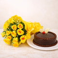 Bouquet of yellow roses and a chocolate cake on a marble surface